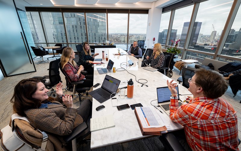 A group of people working together in a conference room