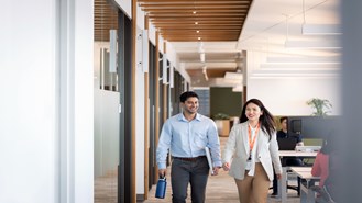 Two employees walking through the office together