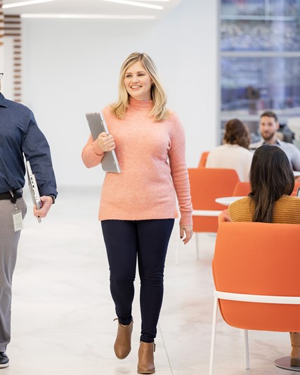 Two employees walking through the office together