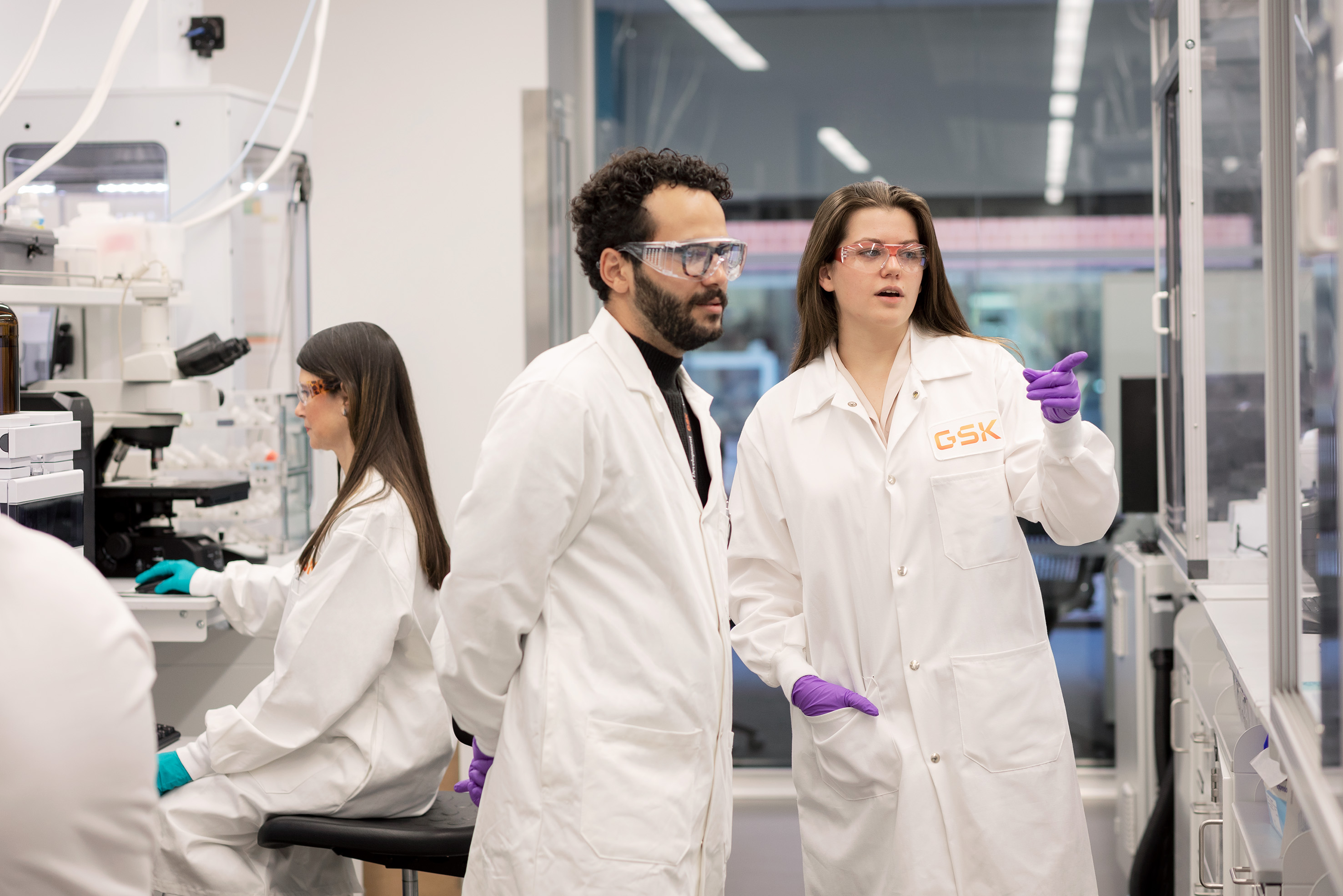 Two scientists discussing work in a lab