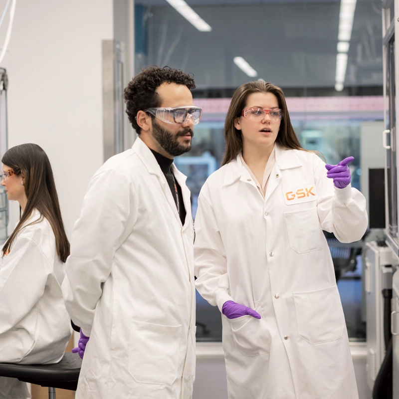 Two scientists discussing work in a lab