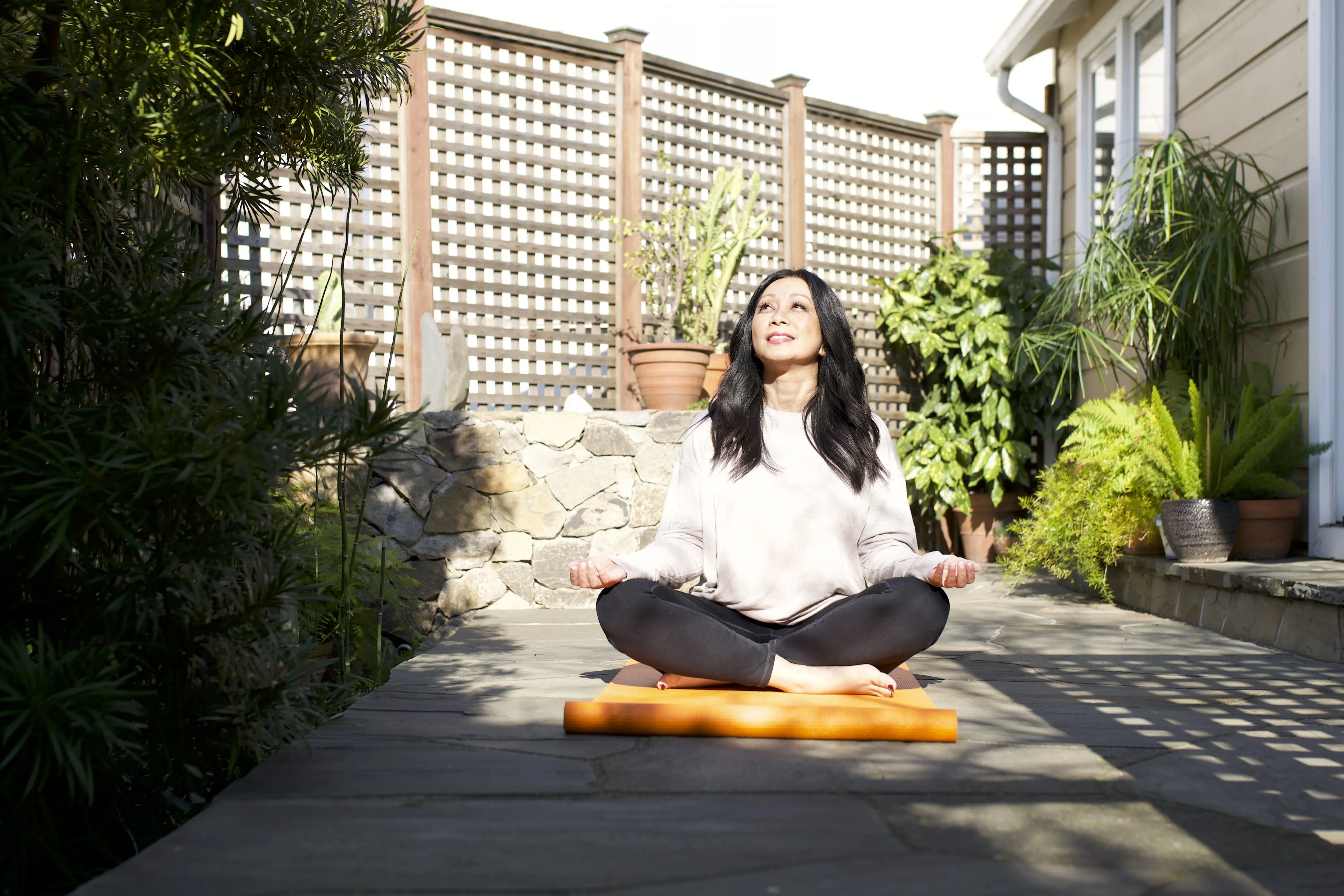 Woman outside on yoga mat.