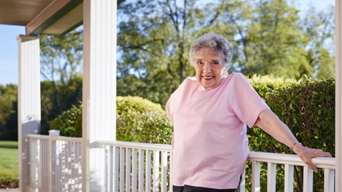 Older lady stood on balcony