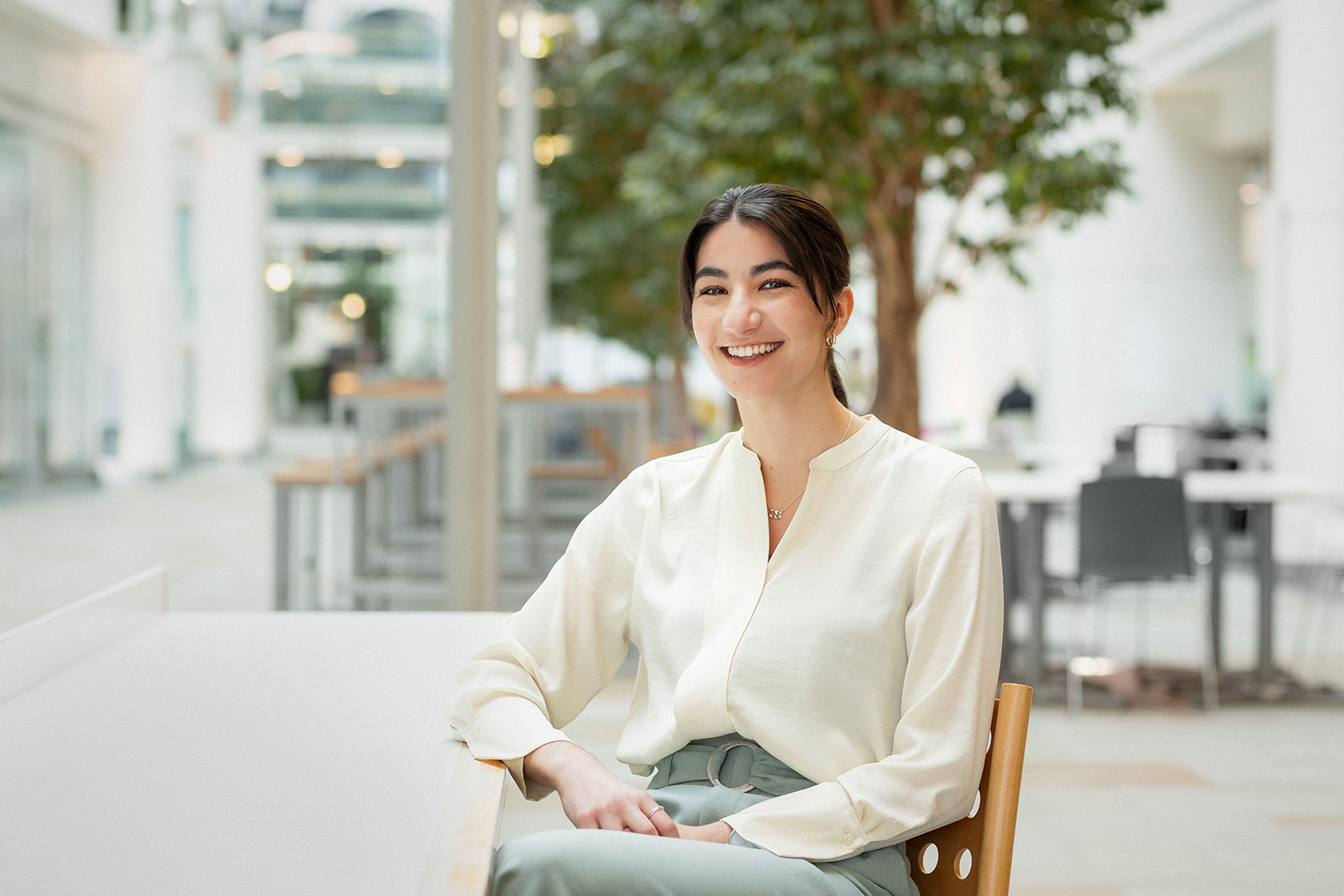 female employee in atrium of a building.