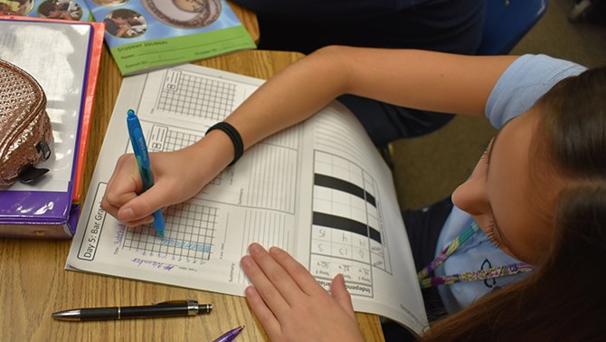 Young student filling out a worksheet