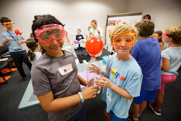 Kids in school doing a science experiment.