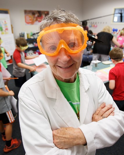 female scientist with orange goggles 