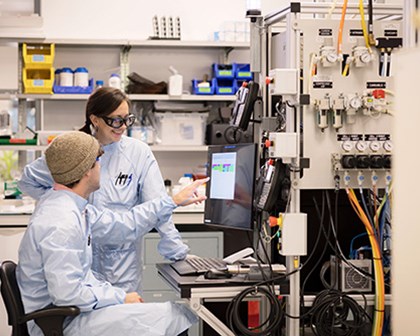 Two scientists studying a screen