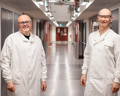Two scientists in a hallway