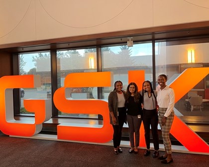 4 female employees standing in front of GSK sign.