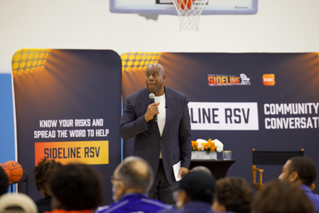 Earvin “Magic” Johnson speaking in front of the Sideline RSV audience.