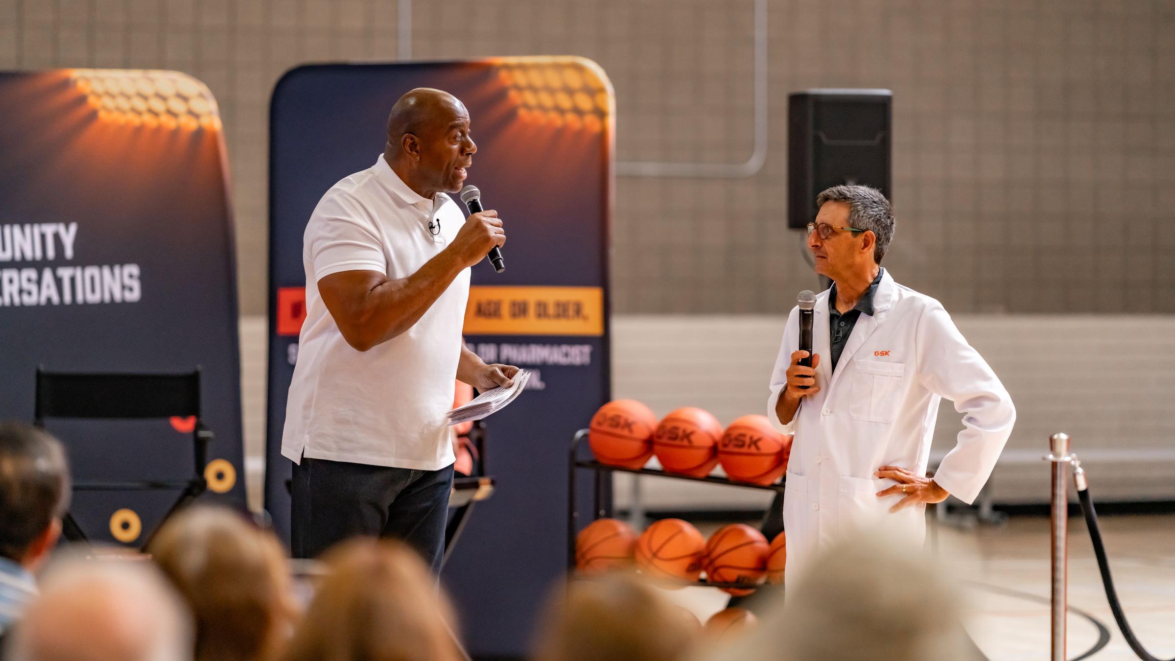 Earvin “Magic” Johnson speaking in front of the Sideline RSV audience with Dr. Len Friedland