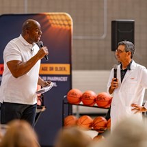 Earvin “Magic” Johnson speaking in front of the Sideline RSV audience with Dr. Len Friedland