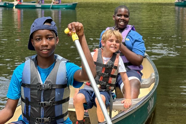 Three teens on a canoe 