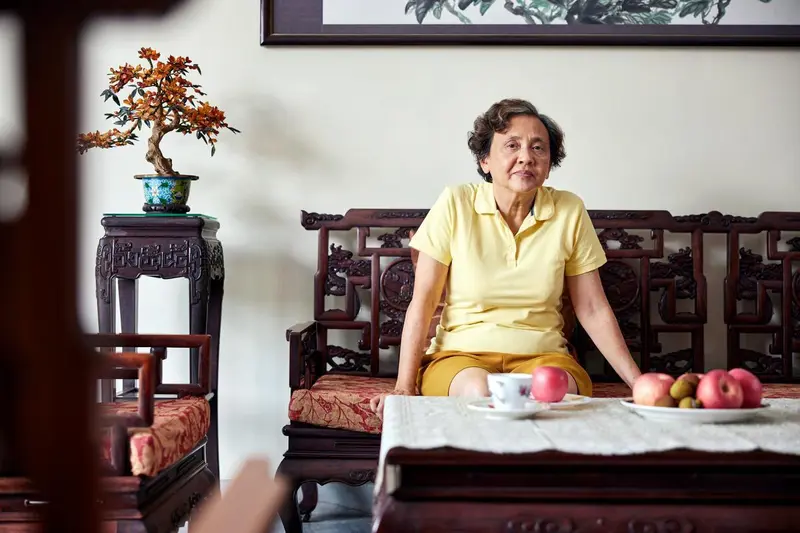 elderly woman sitting in her living room. 