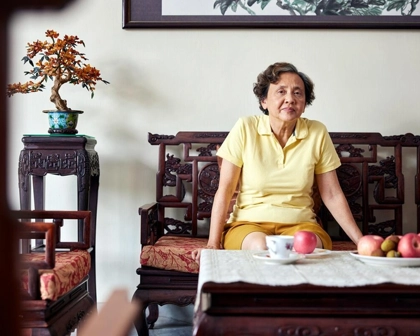 elderly woman sitting in her living room.