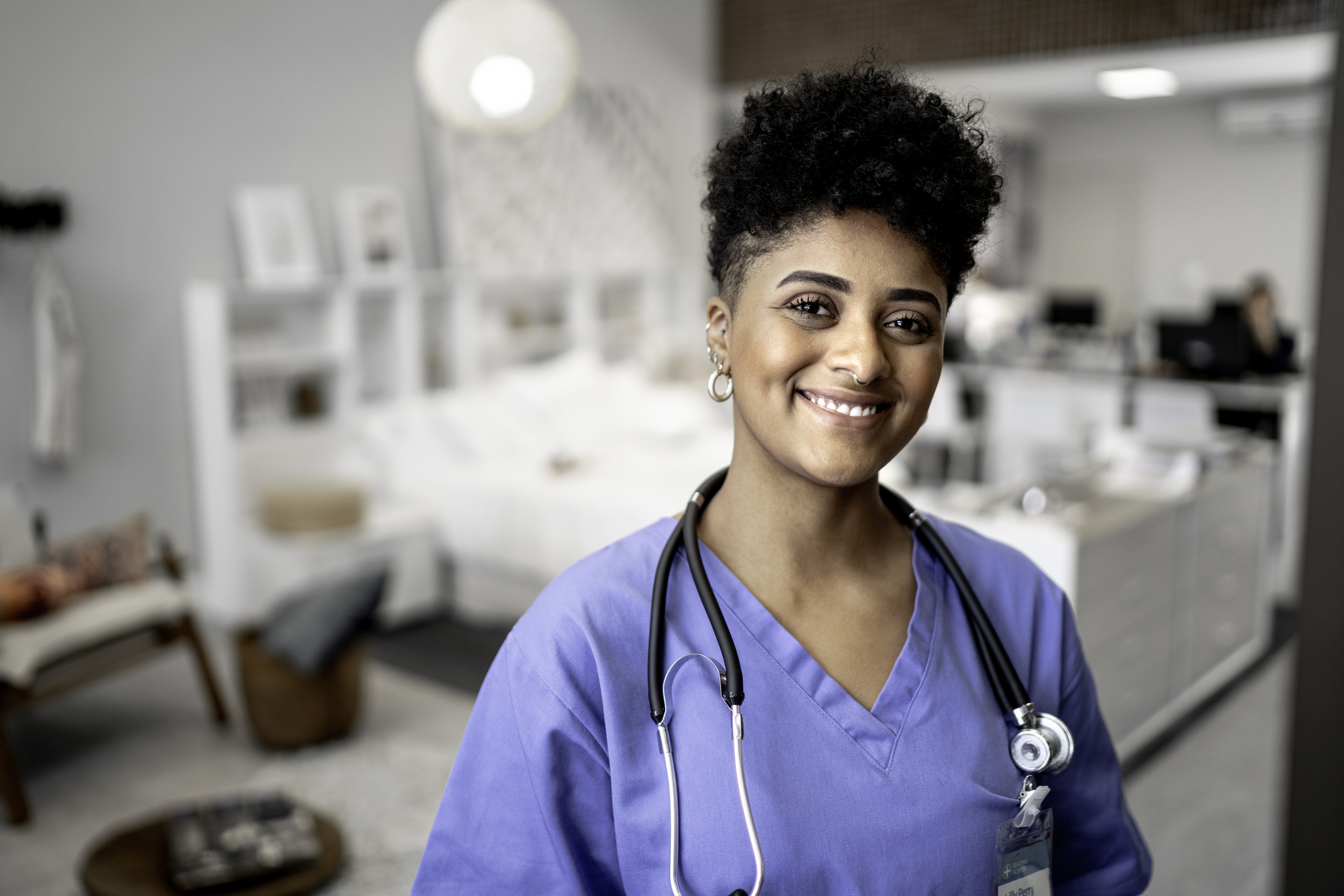Healthcare professional in hospital setting smiling at camera