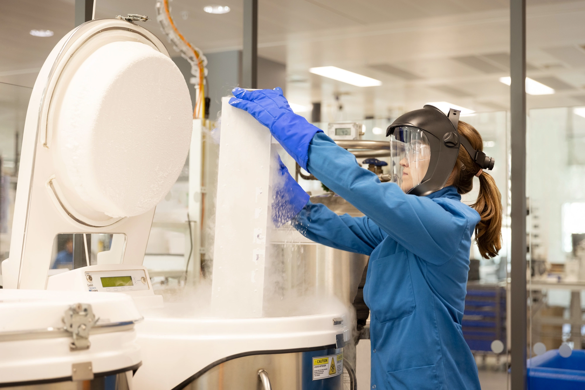 scientist in a lab using a cryogenic machine