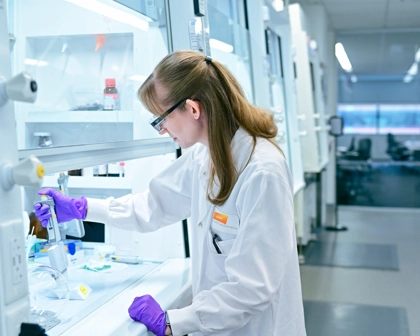 Nicole is a scientist in a lab coat working in the lab