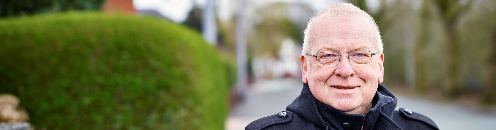 Man with glasses looking at camera