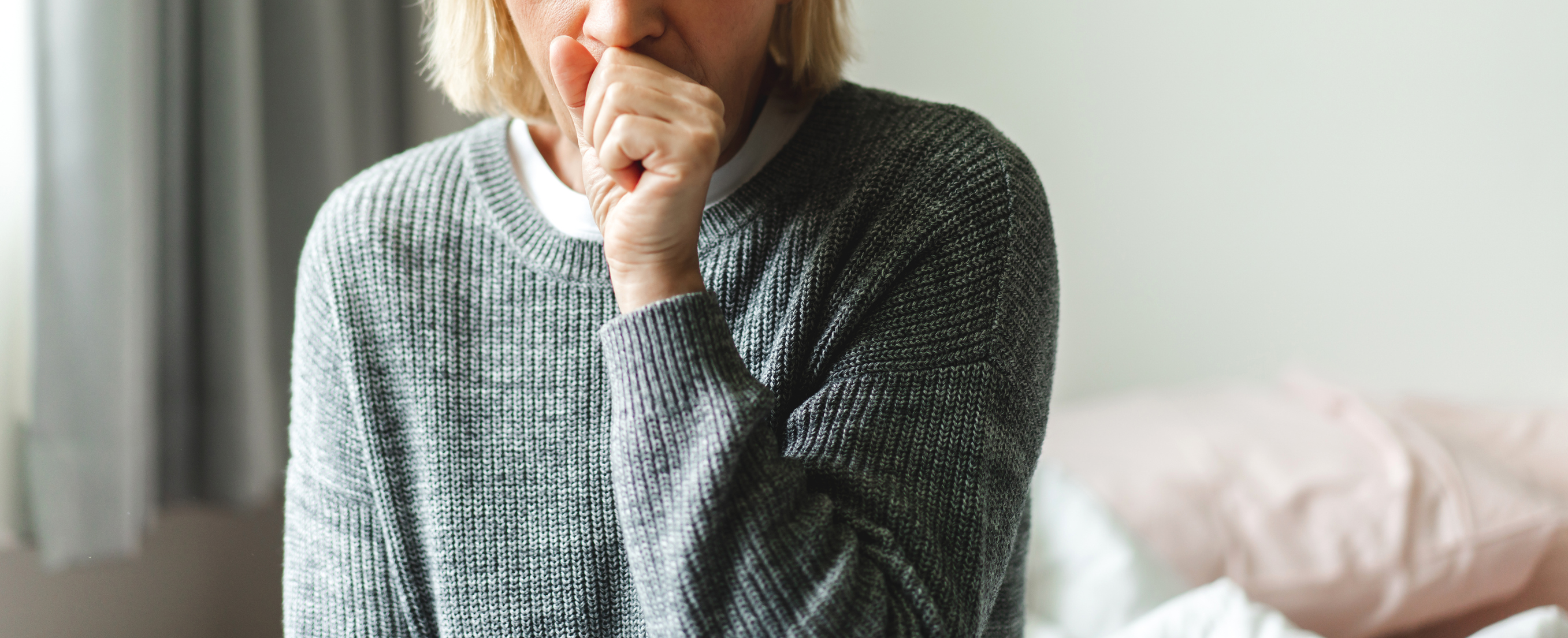 a woman coughing 