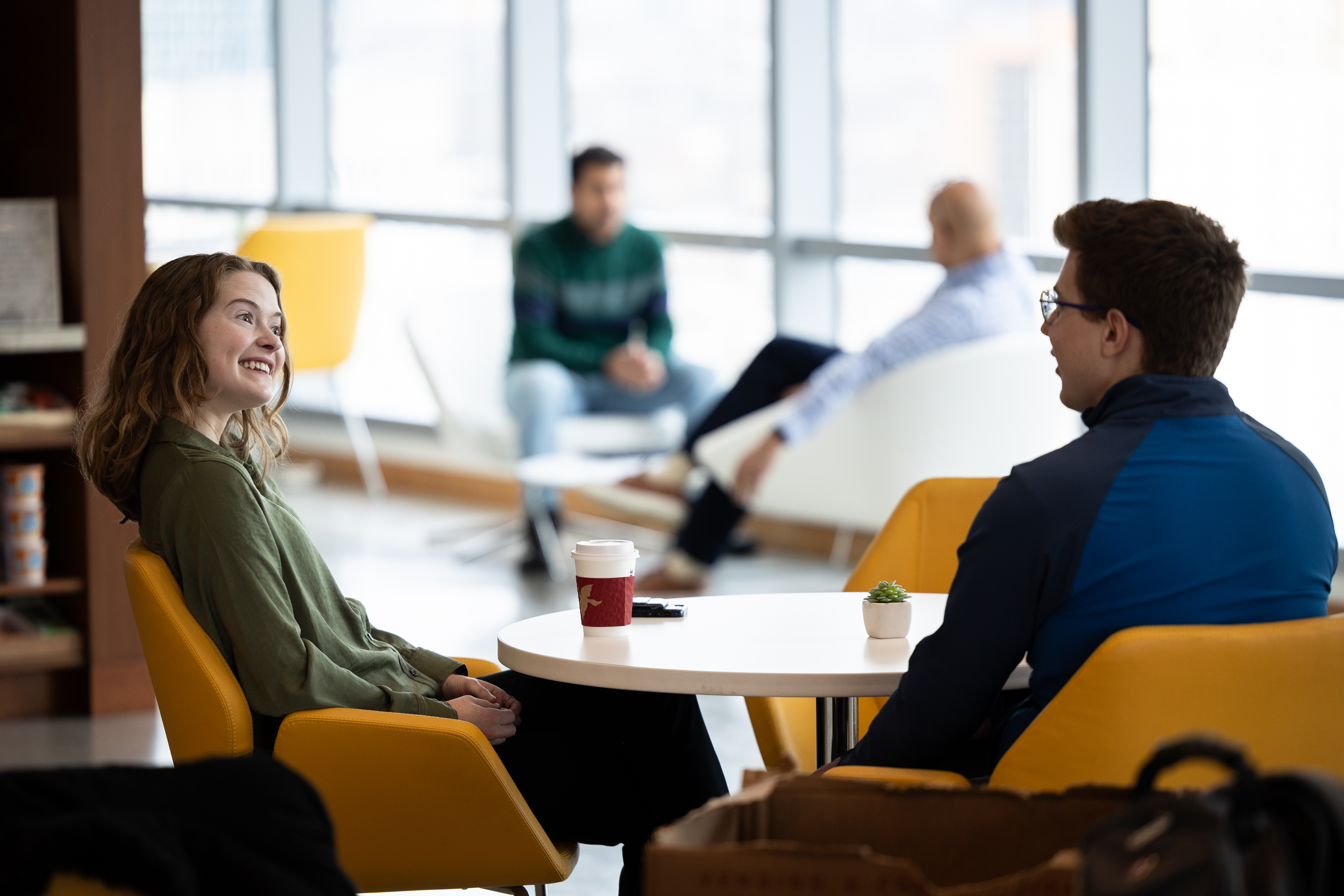 Two employees talking in the office cafe