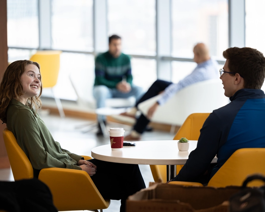 Two employees talking in the office cafe
