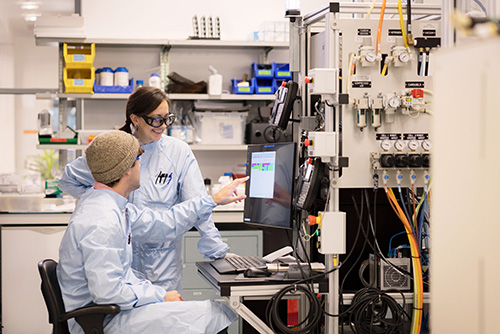 Two scientists studying a screen