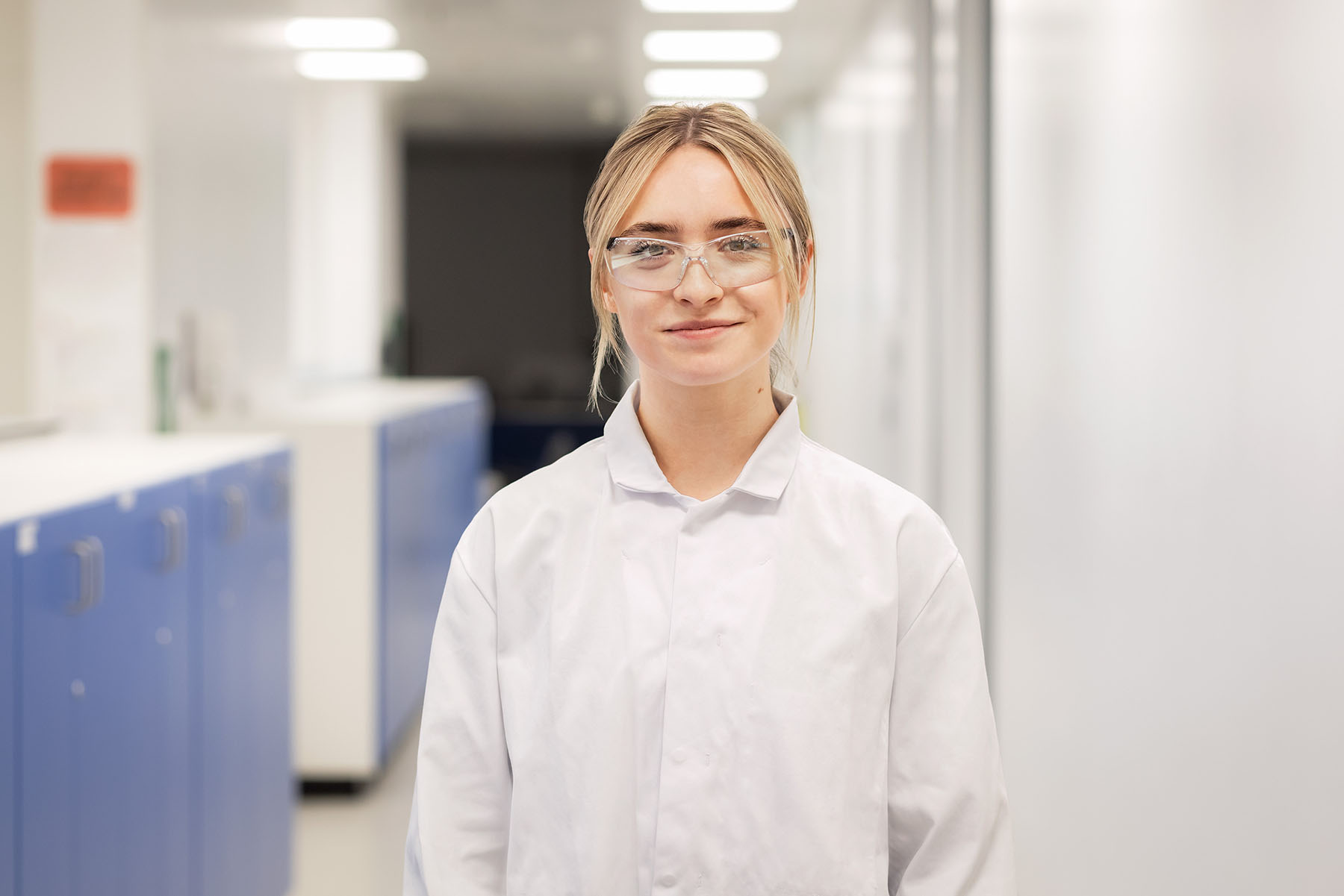 Female scientist standing in the hallway in the lab