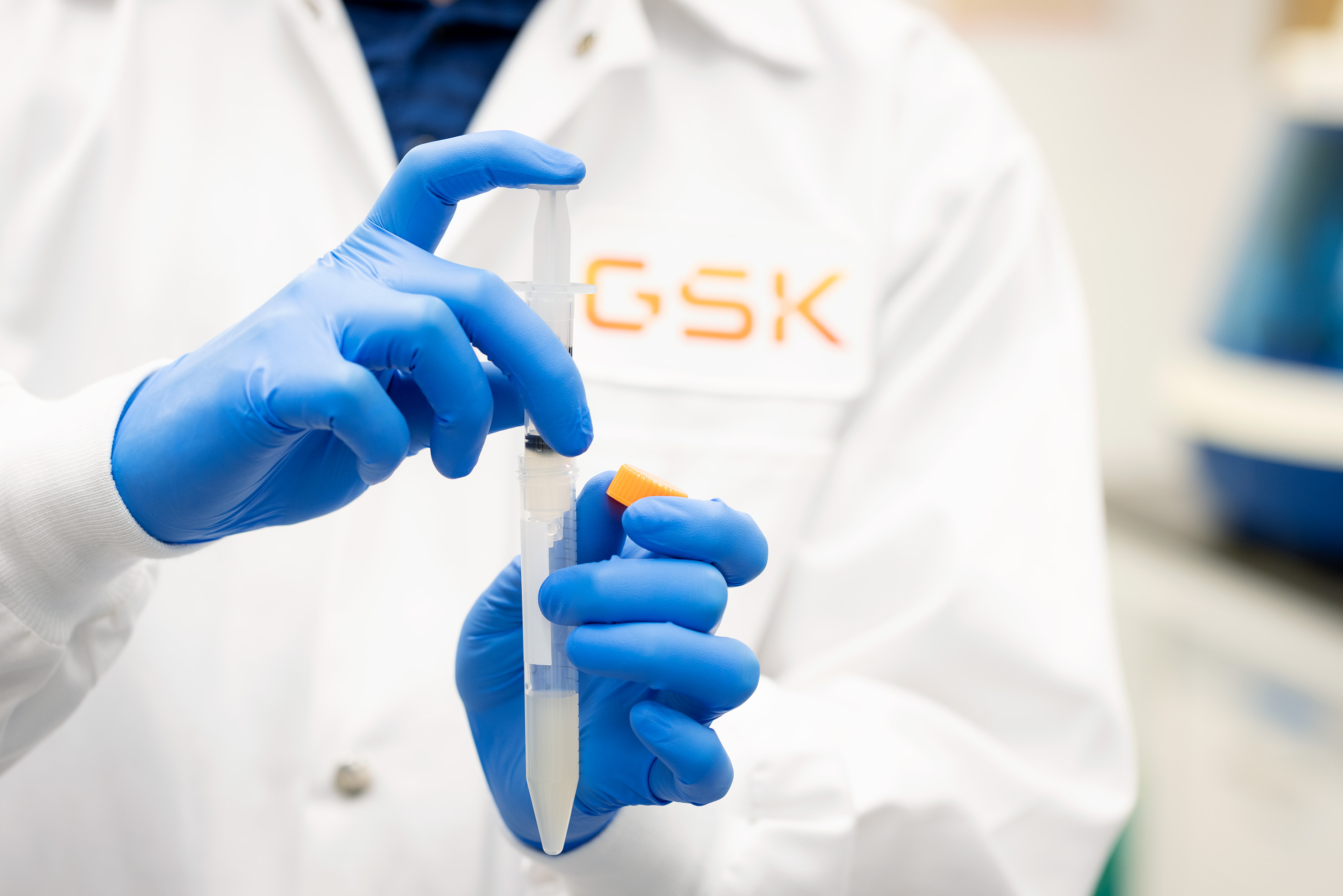 A close-up shot of scientist's hands handling a vial