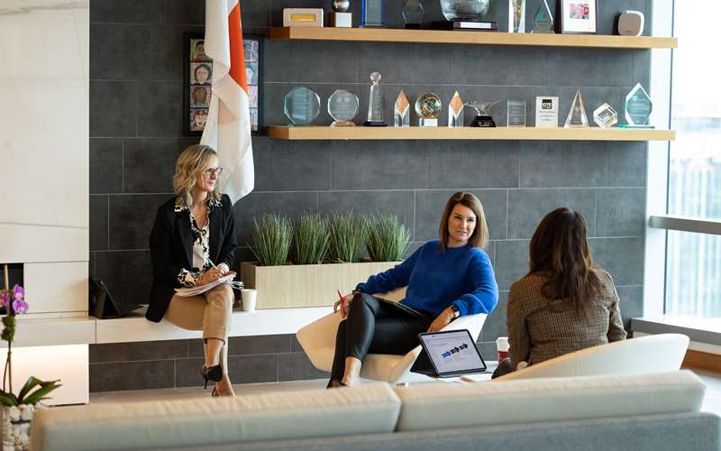A group of employees discussing work in the office