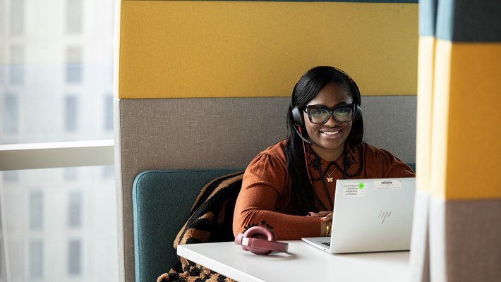 A smiling office employee looking towards the camera