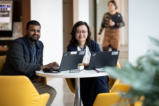 Two office employees smiling