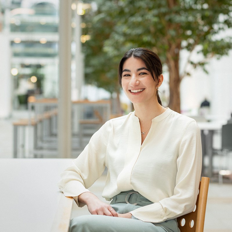 female employee in atrium of a building.