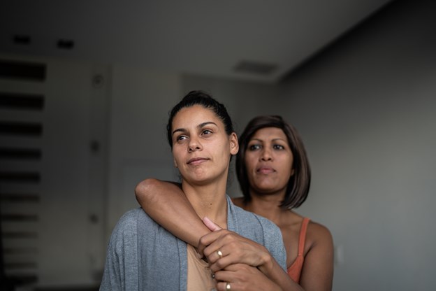 two females holding on to each other