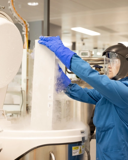 scientist in a lab using a cryogenic machine