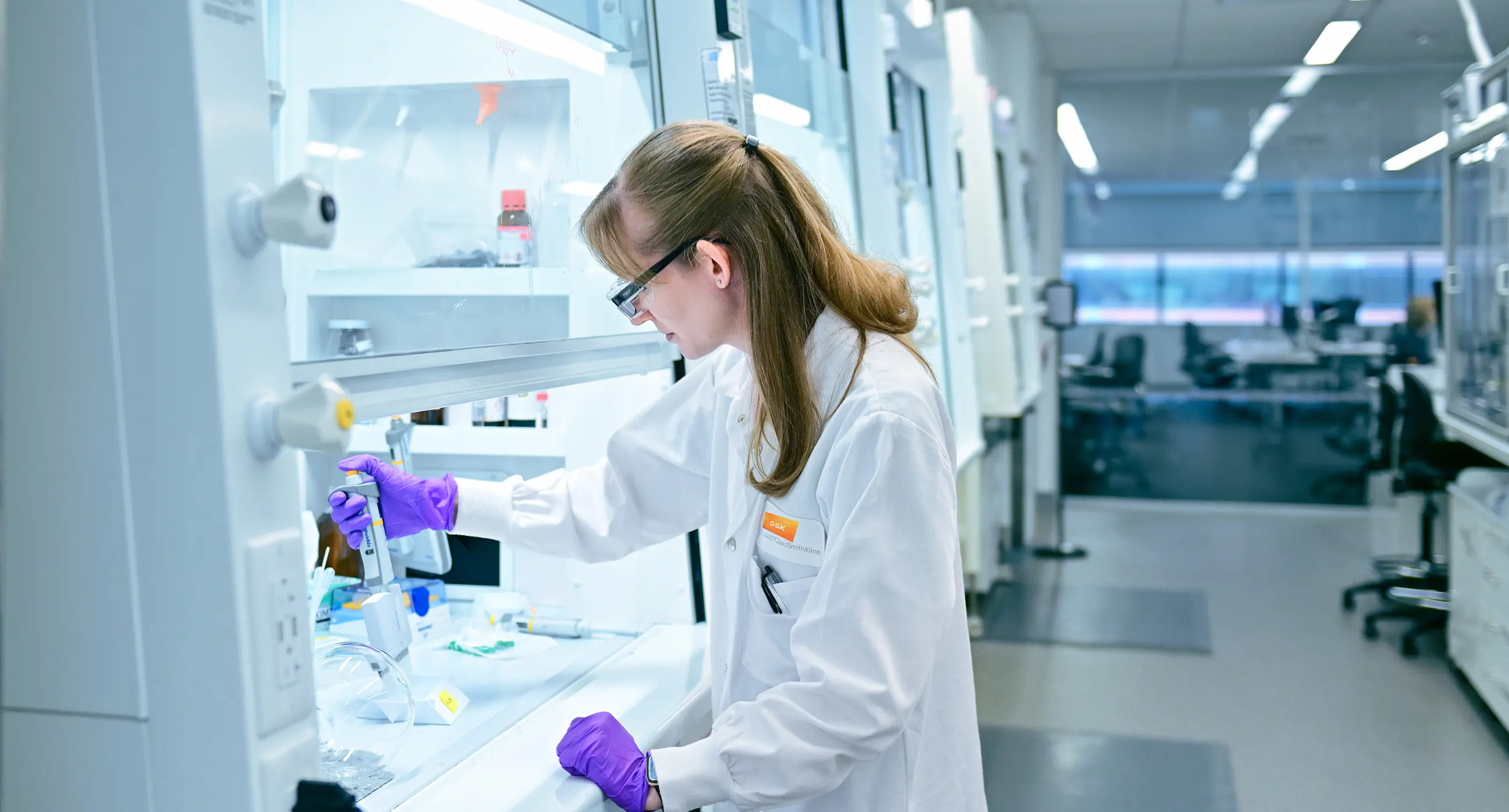 Nicole is a scientist in a lab coat working in the lab