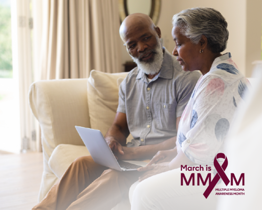 A couple having a conversation and looking at a laptop