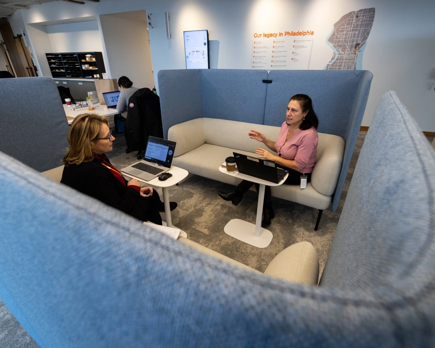 Two employees discussing work in the office